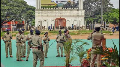 A policeman salutes the national flag, in Bengaluru. (PTI) A policeman salutes the national flag, in Bengaluru. (PTI)