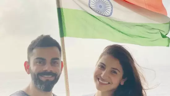 Anushka Sharma and Virat Kohli were all smiles as they posed along with the national flag in the backdrop. Anushka shared the picture and captioned it, "#HappyIndependenceDay."(Instagram/@anushkasharma)