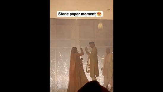 The image, taken from the viral video, shows the bride and groom playing ‘rock paper scissors’ before varmala.&nbsp;(Instagram/@weddingwireindia)