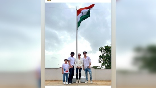 Shah Rukh Khan celebrated the 75th Independence Day with his wife Gauri Khan and sons AbRam Khan and Aaryan Khan. All dressed in white, they posed in front of the national flag.(Instagram/@gaurikhan)