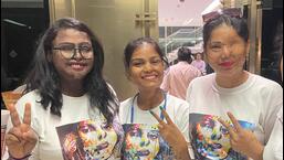 Rupali Vishwakarma (L to R ), Kunti Soni, and Farah Khan posing with victory signs and T-shirts with the message, 