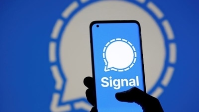 The Signal messaging app logo is seen on a smartphone, in front of the same displayed same logo, in this illustration. (Reuters)