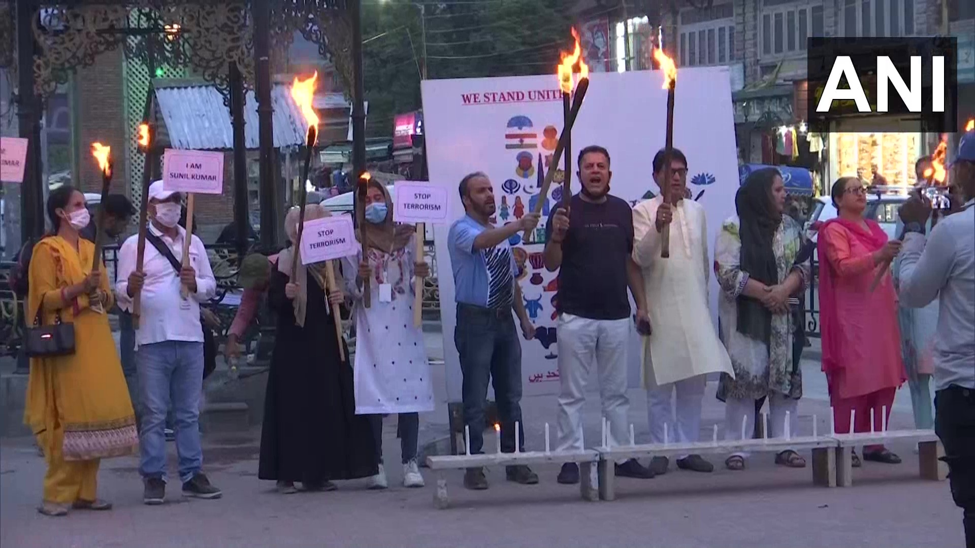 People hold a protest near Clock Tower (Ghanta Ghar) at Lal Chowk in Srinagar.