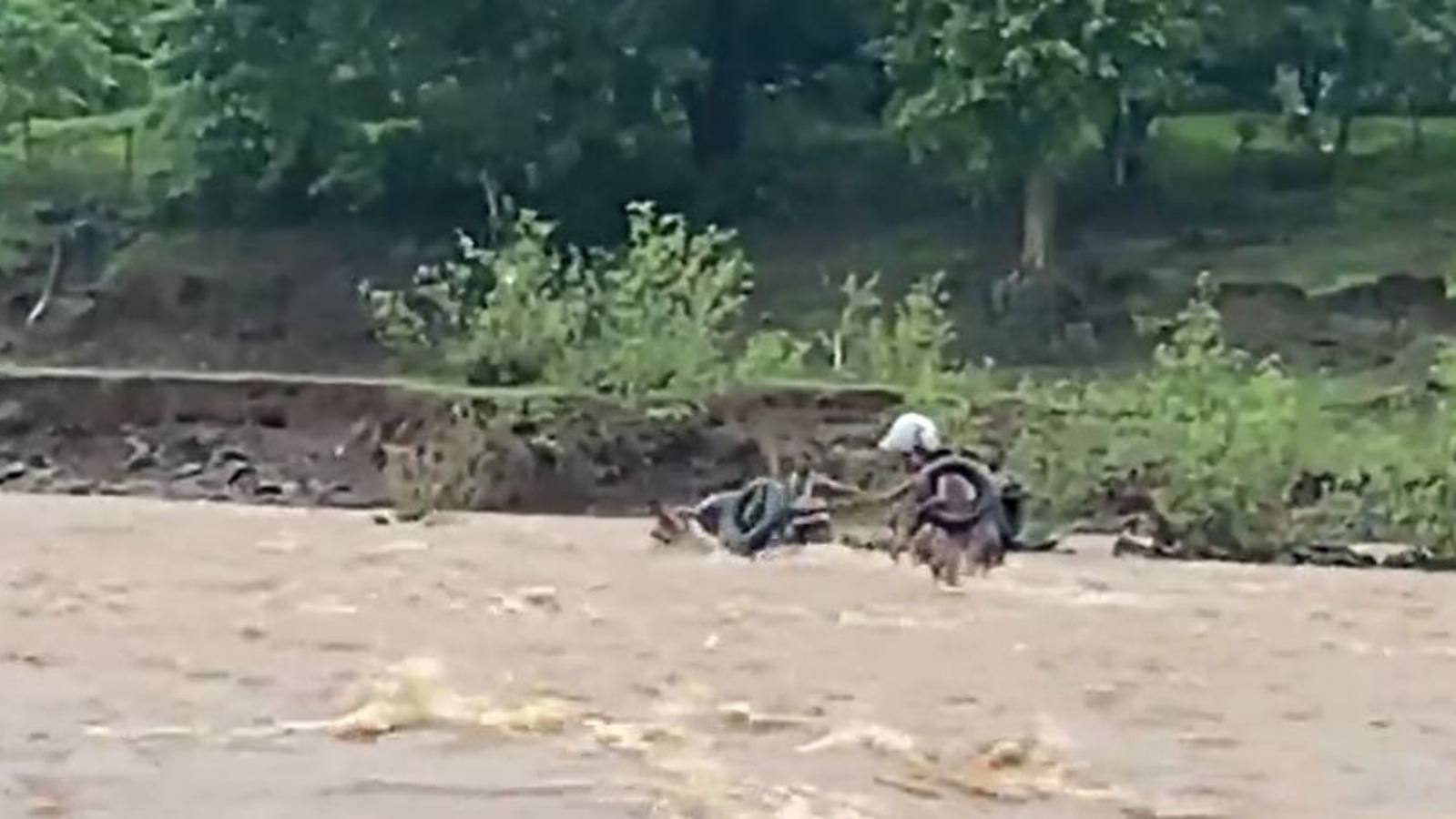 Villagers here swim across a river for daily essentials. Watch their