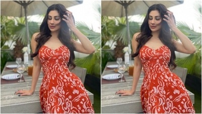 Styled by fashion stylist Rishika Devnani, Mouni wore her tresses open in soft wavy curls with a middle part. (Instagram/@imouniroy)