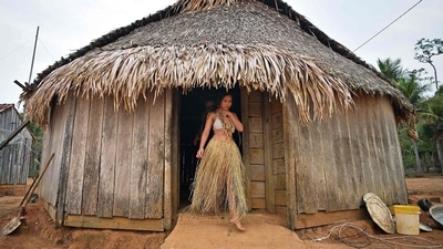 (FILES) A young woman from the Uru Eu Wau Wau tribe gets out from a straw-thatched hut in the tribe's reserve in the Amazon, south of Porto Velho, Brazil. (AFP) (FILES) A young woman from the Uru Eu Wau Wau tribe gets out from a straw-thatched hut in the tribe's reserve in the Amazon, south of Porto Velho, Brazil. (AFP)