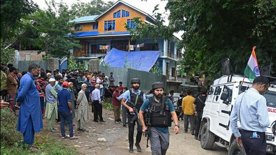 Security forces outside the house of Sunil Kumar Bhat. (AFP)