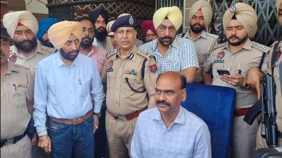 Additional director general of police (ADGP), internal security, RN Dhoke (sitting) with Punjab Police sub inspector Dilbagh Singh (standing left) at his house at Ranjit Avenue, Amritsar, on Wednesday, a day after an IED was recovered from under his SUV. (Sameer Sehgal/HT)