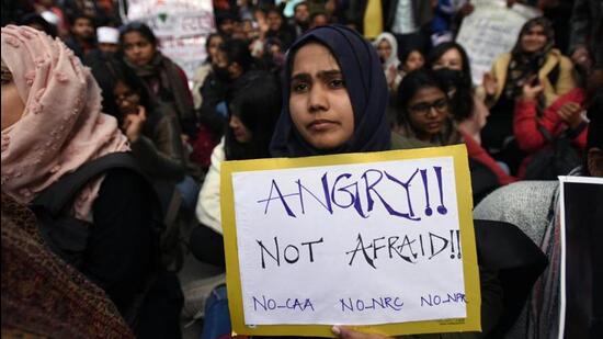 A girl holds a placard during a protest against Citizenship Amendment Act, National Register of Citizens and National Population Register. (Amal KS/HT File Photo)
