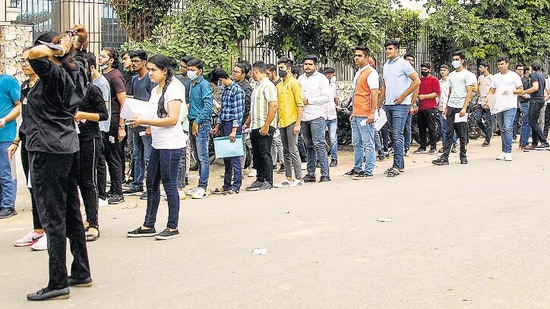 Students line up outside a CUET centre in Noida on Wednesday. (PTI)