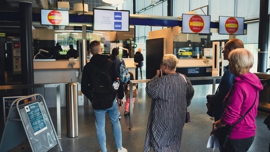 This file photo shows Russian tourists having their passport checked at the Nuijamaa border crossing, Finland. Finland will limit Russian tourist visas to 10 percent of current volumes as of September 1 due to rising discontent over Russian tourism amid the war in Ukraine, the Finnish government said &nbsp;(Photo by Alessandro RAMPAZZO / AFP)