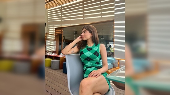 Khushi Kapoor shared a series of photos of herself donning a short green and black bodycon checkered ribbed-knit dress and added green nature-related emojis to the caption.(Instagram/@khushi05k)