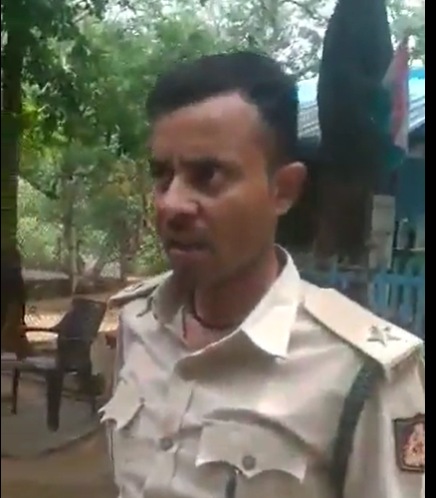 The officer is seen threatening to shoot the truck drivers at a check post in Karnataka in an intoxicated state. The officer is seen threatening to shoot the truck drivers at a check post in Karnataka in an intoxicated state.