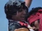 Amitabh Bachchan and Abhishek Bachchan in stills from Khud-Daar and Happy New Year respectively. Amitabh Bachchan and Abhishek Bachchan in stills from Khud-Daar and Happy New Year respectively.