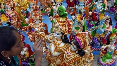 A street vendor paints an idol of Lord Krishna to sell on the eve of Krishna Janmashtami festival. His idol is said to bring good luck to one's home. The flute symbolises unity and harmony as it's sweet melody is said to bring everyone together. (Shashidhar Byrappa) A street vendor paints an idol of Lord Krishna to sell on the eve of Krishna Janmashtami festival. His idol is said to bring good luck to one's home. The flute symbolises unity and harmony as it's sweet melody is said to bring everyone together. (Shashidhar Byrappa)
