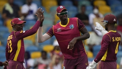 West Indies' Shamarh Brooks, left, celebrates with teammates Jason Holder and Shai Hope after taking the catch to dismiss New Zealand's Devon Conway during the first ODI at Kensington Oval in Bridgetown, Barbados (AP) West Indies' Shamarh Brooks, left, celebrates with teammates Jason Holder and Shai Hope after taking the catch to dismiss New Zealand's Devon Conway during the first ODI at Kensington Oval in Bridgetown, Barbados (AP)
