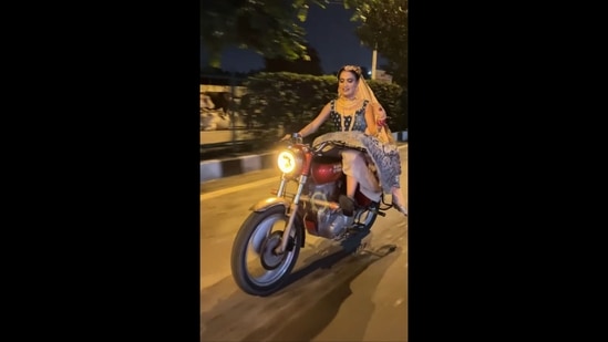 A screengrab of the viral video posted on Instagram. It shows a woman dressed in bridal attire riding a Royal Enfield Bullet.&nbsp;(Instagram/@vaishali_chaudhary_khutail)