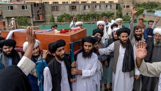 Mourners carry the body of a victim of the mosque bombing in Kabul, Afghanistan.(AP)