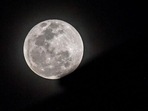The full moon rises behind an apartment building during lunar eclipse. (AFP/Representative image)