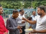 A man offers sweets to people convicted for rape and murder in the Bilkis Bano case of the 2002 post-Godhra riots, after they came out of the Godhra sub-jail.(PTI) A man offers sweets to people convicted for rape and murder in the Bilkis Bano case of the 2002 post-Godhra riots, after they came out of the Godhra sub-jail.(PTI)
