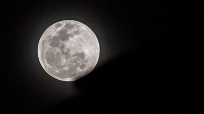 The full moon rises behind an apartment building during lunar eclipse. (AFP/Representative image) The full moon rises behind an apartment building during lunar eclipse. (AFP/Representative image)