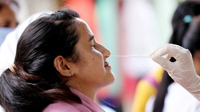 A healthcare worker collects a nasal swab sample of a woman for the Covid-19 testing, amid a recent surge in the Coronavirus cases, in Jammu. (HT Photo) A healthcare worker collects a nasal swab sample of a woman for the Covid-19 testing, amid a recent surge in the Coronavirus cases, in Jammu. (HT Photo)
