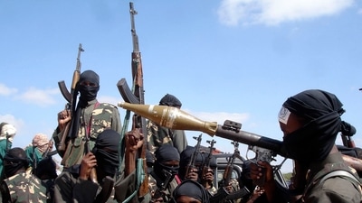 FILE - Armed al-Shabab fighters ride on pickup trucks as they prepare to travel into the city, just outside the capital Mogadishu, Somalia, Dec. 8, 2008.. (AP Photo/Farah Abdi Warsameh, File)