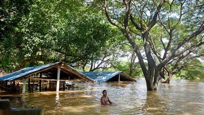 A man wades through a waist-deep waterlogged area as a flood situation in the Mahanadi river system remained unchanged despite a fall in the water flow at the Mundali barrage (ANI File) A man wades through a waist-deep waterlogged area as a flood situation in the Mahanadi river system remained unchanged despite a fall in the water flow at the Mundali barrage (ANI File)