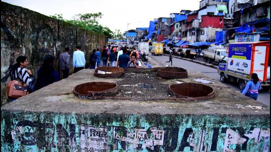 People walk on the footpath near the dismantled skywalk in Bandra on Friday Vijay Bate/HT Photo