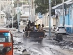 Somali security officers drive past a section of Hotel Hayat, the scene of an al Qaeda-linked al Shabaab group militant attack in Mogadishu, Somalia August 20, 2022. REUTERS/Feisal Omar