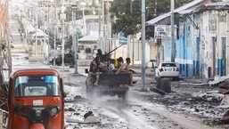 Somali security officers drive past a section of Hotel Hayat, the scene of an al Qaeda-linked al Shabaab group militant attack in Mogadishu, Somalia August 20, 2022. REUTERS/Feisal Omar