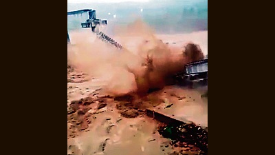 The railway bridge on Chakki river collapses due to a flash flood triggered by heavy rains in Kangra on Saturday. (ANI)