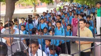 Residents of Kharia village in Hisar standing guard at the school gate on Saturday. (HT Photo) Residents of Kharia village in Hisar standing guard at the school gate on Saturday. (HT Photo)
