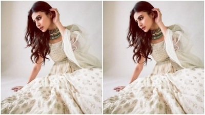 Mouni looked like the epitome of grace in the white anarkali that came intricately embroidered in silver resham threads and silver mirror work at the sleeves. The anarkali featured a round neckline and a flowy detail below the waist. (Instagram/@imouniroy)