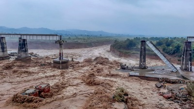 Collapsed portion of railway bridge over the Chakki river after flash flood triggered by heavy monsoon rains. (PTI)