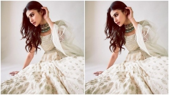 Mouni looked like the epitome of grace in the white anarkali that came intricately embroidered in silver resham threads and silver mirror work at the sleeves. The anarkali featured a round neckline and a flowy detail below the waist.(Instagram/@imouniroy)