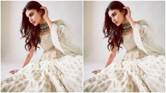 Mouni looked like the epitome of grace in the white anarkali that came intricately embroidered in silver resham threads and silver mirror work at the sleeves. The anarkali featured a round neckline and a flowy detail below the waist.(Instagram/@imouniroy)