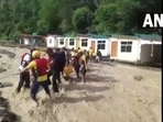 Tourists being rescued by the SDRF team from the resort.(@ANINewsUP/ Twitter) Tourists being rescued by the SDRF team from the resort.(@ANINewsUP/ Twitter)