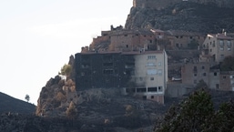 A semi-burnt building stands amid scorched area as wildfires remain active in the Valencia region, in Bejis, Spain.