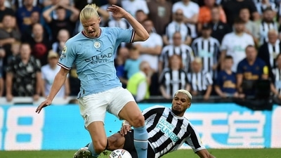 Newcastle's Joelinton, right, challenges Manchester City's Erling Haaland during the English Premier League match (AP)