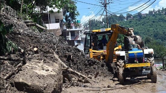 Debris being cleared from a road in Mandi on Sunday. (Birbal Sharma/HT)