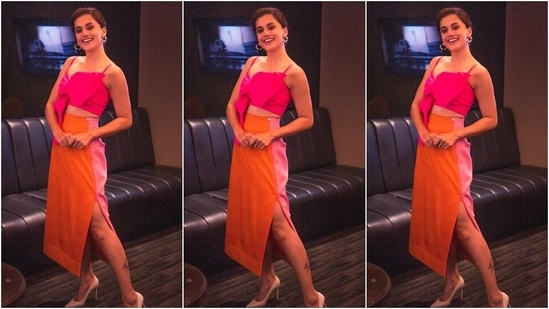 Taapsee made a case for colour-block fashion in this ensemble featuring a hot pink crop top and orange-pink double-tone skirt with a side thigh-high slit. Pointed pumps, hoop earrings and subtle makeup concluded the look.(Instagram/@dev213)
