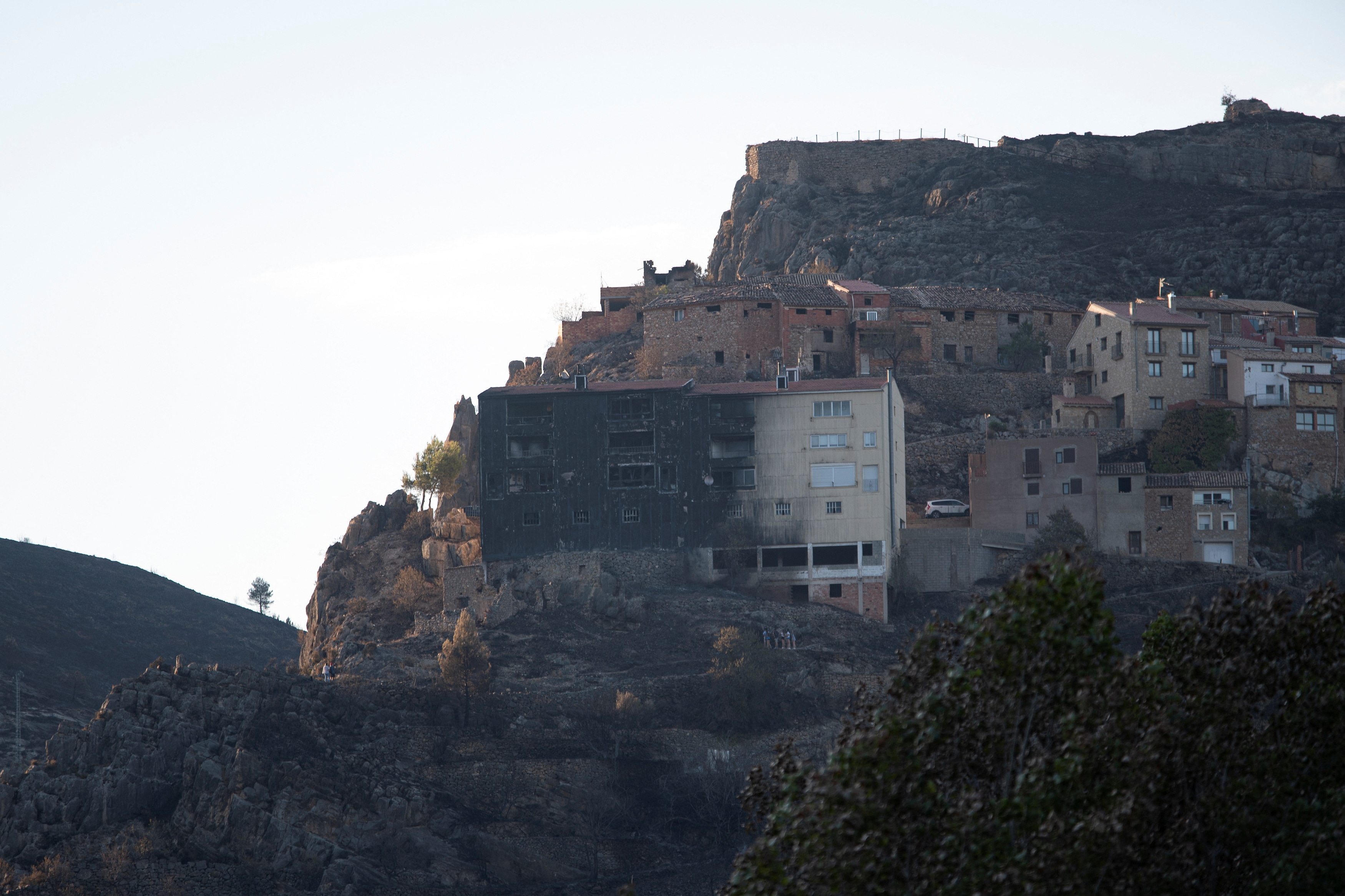 A semi-burnt building stands amid scorched area as wildfires remain active in the Valencia region, in Bejis, Spain. (Reuters)