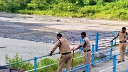 The Nainital Police personnel at Gaula barrage overseeing the search operation to find the two teenagers who drowned in the river. (HT Photo)
