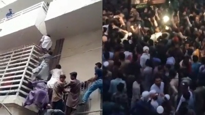 A charged mob gathered around an apartment building to get hold of the Hindu sanitation worker. (Twitter) A charged mob gathered around an apartment building to get hold of the Hindu sanitation worker. (Twitter)
