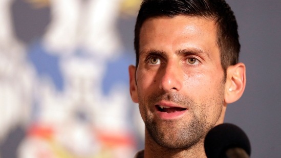 Novak Djokovic speaks during a press conference.(AFP)
