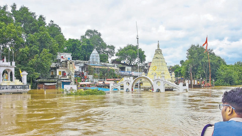 Jabalpur: A partially submerged temple in floodwater along the Narmada river, swollen due to incessant monsoon rainfall, in Jabalpur. (PTI) Jabalpur: A partially submerged temple in floodwater along the Narmada river, swollen due to incessant monsoon rainfall, in Jabalpur. (PTI)