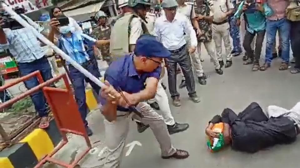 ADM (law & order) KK Singh hits a protester with a baton in Patna on Monday. (PTI) ADM (law & order) KK Singh hits a protester with a baton in Patna on Monday. (PTI)