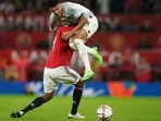 Luis Diaz is tackled by Raphael Varane during the Premier League match between Manchester United and Liverpool at Old Trafford.(AP) Luis Diaz is tackled by Raphael Varane during the Premier League match between Manchester United and Liverpool at Old Trafford.(AP)