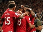Manchester United's Marcus Rashford celebrates with his teammates after scoring his side's second goal during the English Premier League soccer match between Manchester United and Liverpool at Old Trafford stadium.